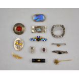 An interesting collection of Victorian and later brooches including Victorian carved jet brooch