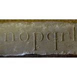 An antique sandstone beam carved on two sides with the letters of the alphabet a-z, 77 cm long x