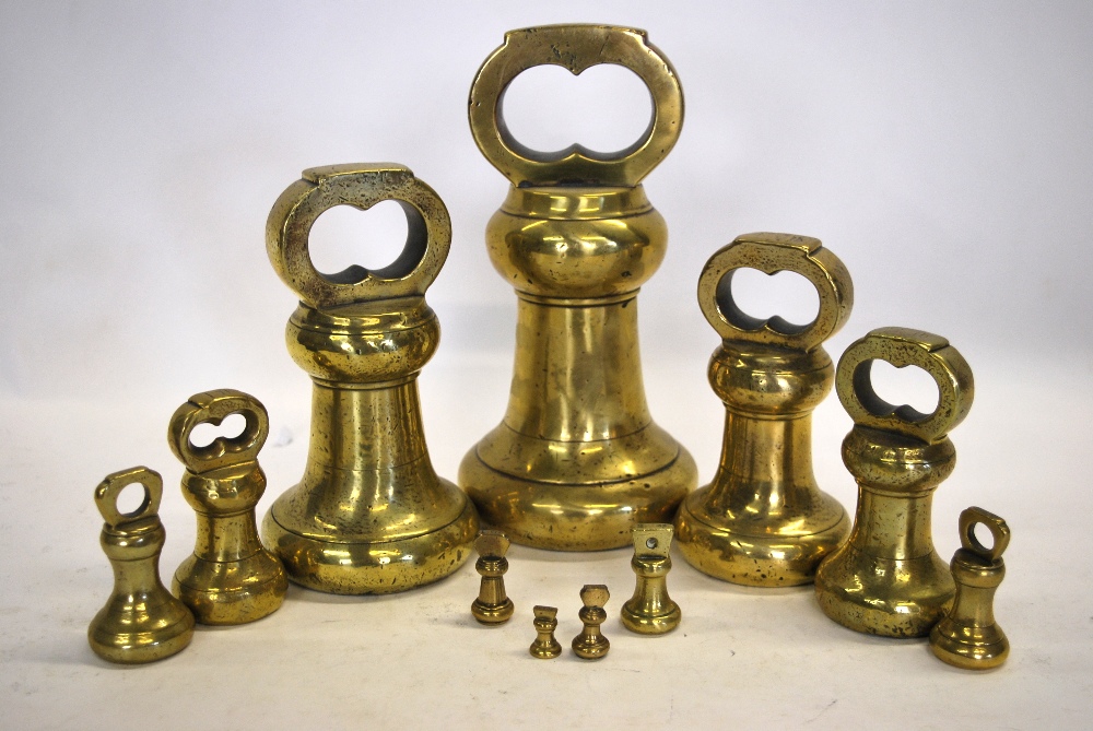 A matched graduated set of eleven brass bell-weights from 14lb to quarter ounce