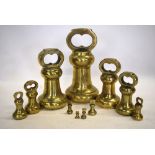 A matched graduated set of eleven brass bell-weights from 14lb to quarter ounce