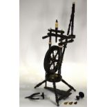 A 19th century ebonised spinning wheel with turned and carved bone fittings,