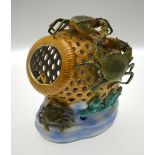 A Continental porcelain lamp in the form of a crab pot decorated in relief with crabs inside and