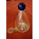 An antique Bristol glass bird feeder with blue ball finial on drop shape body with drawn spout,