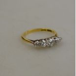 An 18ct gold and platinum ring claw-set with five graduated brilliant-cut diamonds,