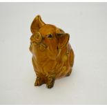 A mustard glazed piggy bank/match striker, 10 cm high Condition Report small chip to front left