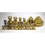 A selection of brass bell-weights, including four 7 lb, four 2 lb,