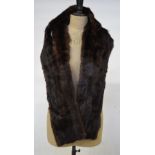 Two boxes containing a fur shoulder cape, three deep musquash fur stoles, a fox fur pieces,