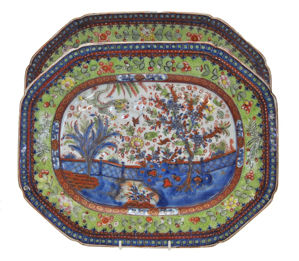 A graduated pair of Chinese 'clobbered' chamfered rectangular meat plates decorated with plants