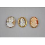 Three shell cameo brooches featuring females, one in 9ct frame,
