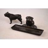 A brown patinated bronze pen-tray surmounted by a seated bulldog puppy,