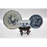 A Chinese blue and white shallow bowl decorated with a stylised bird amidst flowers and foliage, mid