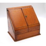 A Victorian mahogany slope front table stationery box with integral day-date-month calendar,