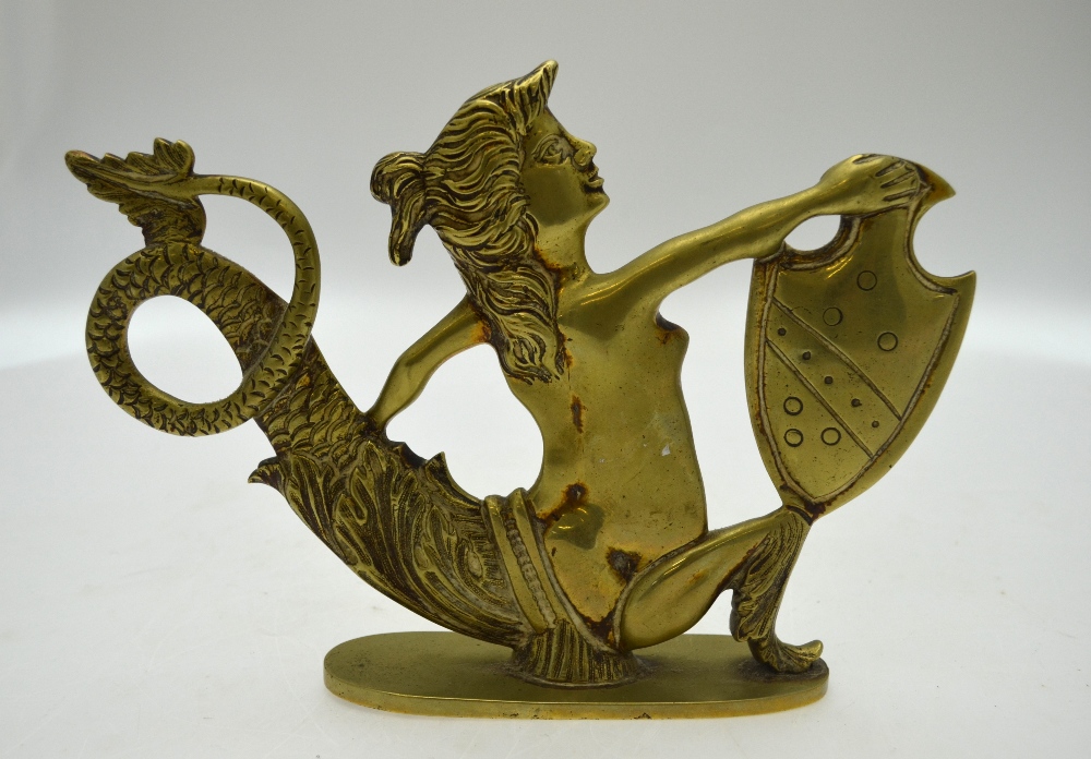 A brass mermaid figure holding a shield - to be viewed from both sides - probably a launch's