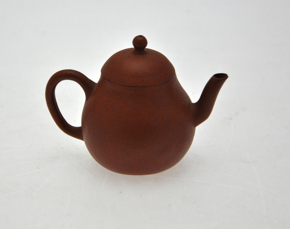 A Chinese miniature Yixing teapot, seal marks to the base, 6.5 cm h. Condition Report Chip to spout,