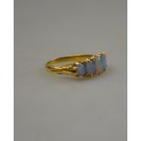 A black opal five stone ring with rose points between, 18ct yellow gold carved claw setting,