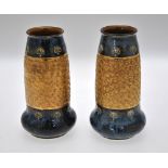 A pair of Royal Doulton vases, blue ground, decorated with a wide band of gilded swirls, 20 cm (2)