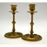 A pair of 19th century gilt brass candlesticks with engraved grease-pans,