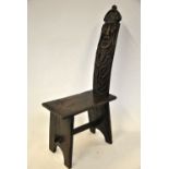 A part 17th century oak chair with figural carved back over a plank seat,