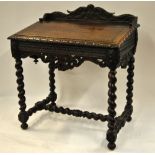 A Victorian oak slop top desk, carved overall in the 17th century style,