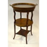 A Sheraton Revival inlaid walnut circular standing having a glass panelled twin-handled tray top