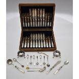 An Edwardian oak cased set of twelve each dessert knives and forks with mother-of-pearl handles