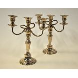 A pair of electroplated twin branch baluster candlesticks with three sconces,