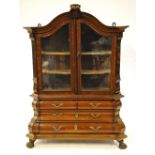 A miniature 19th century Dutch walnut display cabinet on bombe chest,