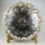 A George II silver salver with shell and gadroon-cast scrolling rim, floral and scroll-engraved
