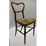 A set of four 19th century gilt decorated rosewood side chairs having over-stuffed tapestry seat