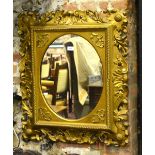 A Victorian giltwood framed mirror with ovoid plate aperture,