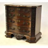 A miniature Chippendale style serpentine chest of four long graduated drawers flanked by blind