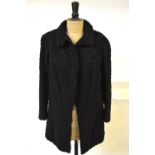 A vintage black Astrakhan fur jacket, retailed by L. Godel, Wilmslow Road, Didsbury, 51 cm across
