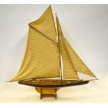 A wooden model of a J-Class yacht, in full sail, 110 x 117 cm overall,