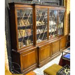 A Victorian mahogany breakfront library bookcase, the moulded cornice over four astragal glazed