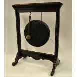 A Victorian red walnut gong stand with chain suspended circular gong complete with hammer,