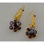 A pair of garnet cluster drop earrings, yellow metal set,