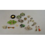 An Arts and Crafts dress clip set with carved green stone plaque,