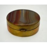 An antique oval patch box having banded agate, gilt metal mounts, hinged lid and closing mirror,