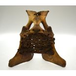 A North American tribal stool (or head-rest) constructed from a deer's pelvis with woven leather