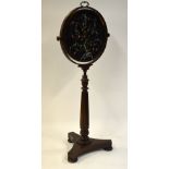 A Regency rosewood rise and fall pole screen with a circular adjustable fabric panelled screen