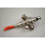 A Victorian baby's silver rattle with chased decoration, coral teether, five bells and a whistle,