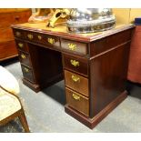 A Victorian style mahogany leather top pedestal desk with nine drawers,