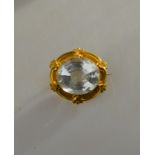 A Victorian bloomed gold brooch set with oval pale aquamarine