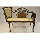 A late 19th century inlaid mahogany salon sofa having a chair back to one end,