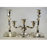 A pair of Victorian loaded silver baluster candlesticks with detachable grease-pans, on shaped