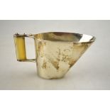 A modern design cream jug of wedge form, the riveted handle with two-piece ivory handle,