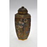 A Japanese cloisonne hexagonal vase and cover decorated with roundels of flower heads on a gilt