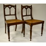 A set of six oak framed Victorian Gothic side chairs with cane seats (6)