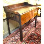 A George III mahogany three-quarter galleried top side table having a full width drop leaf flanked