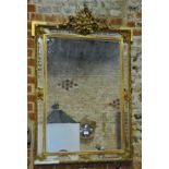 A 19th century giltwood and plaster framed overmantel mirror, the ribbon bow surmount over etched